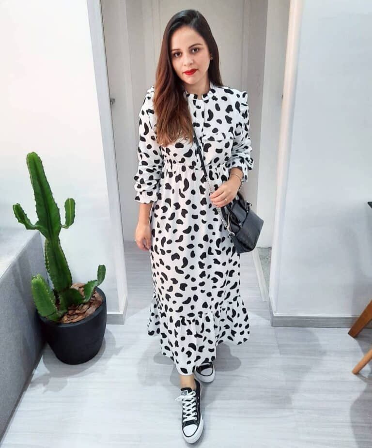 Imagem com vestido casual com estampa de vaca e tênis preto